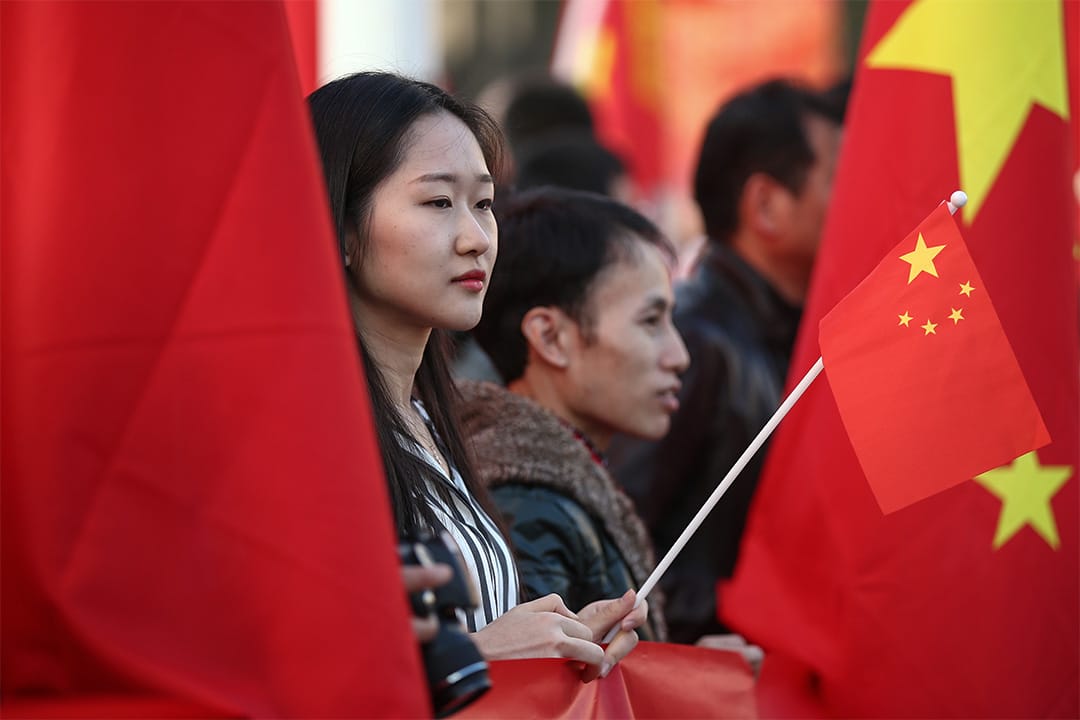 一個年青人手持中國國旗。