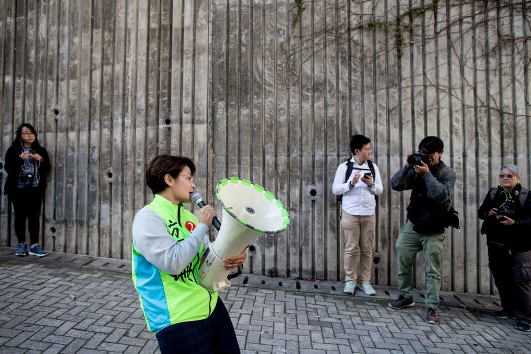 方國珊在調景嶺用咪高峰向樓上住戶進行拉票。