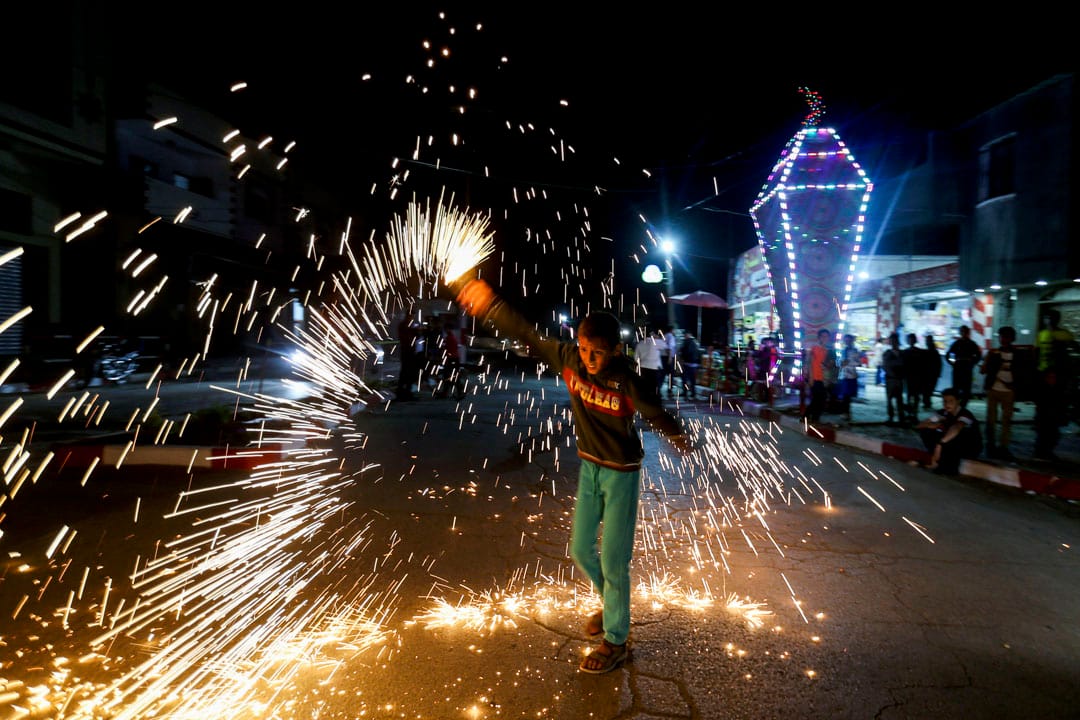 2020年4月22日,加沙地带南部,一名巴勒斯坦男孩在斋戒月前庆祝活动时挥舞著自制的烟火。