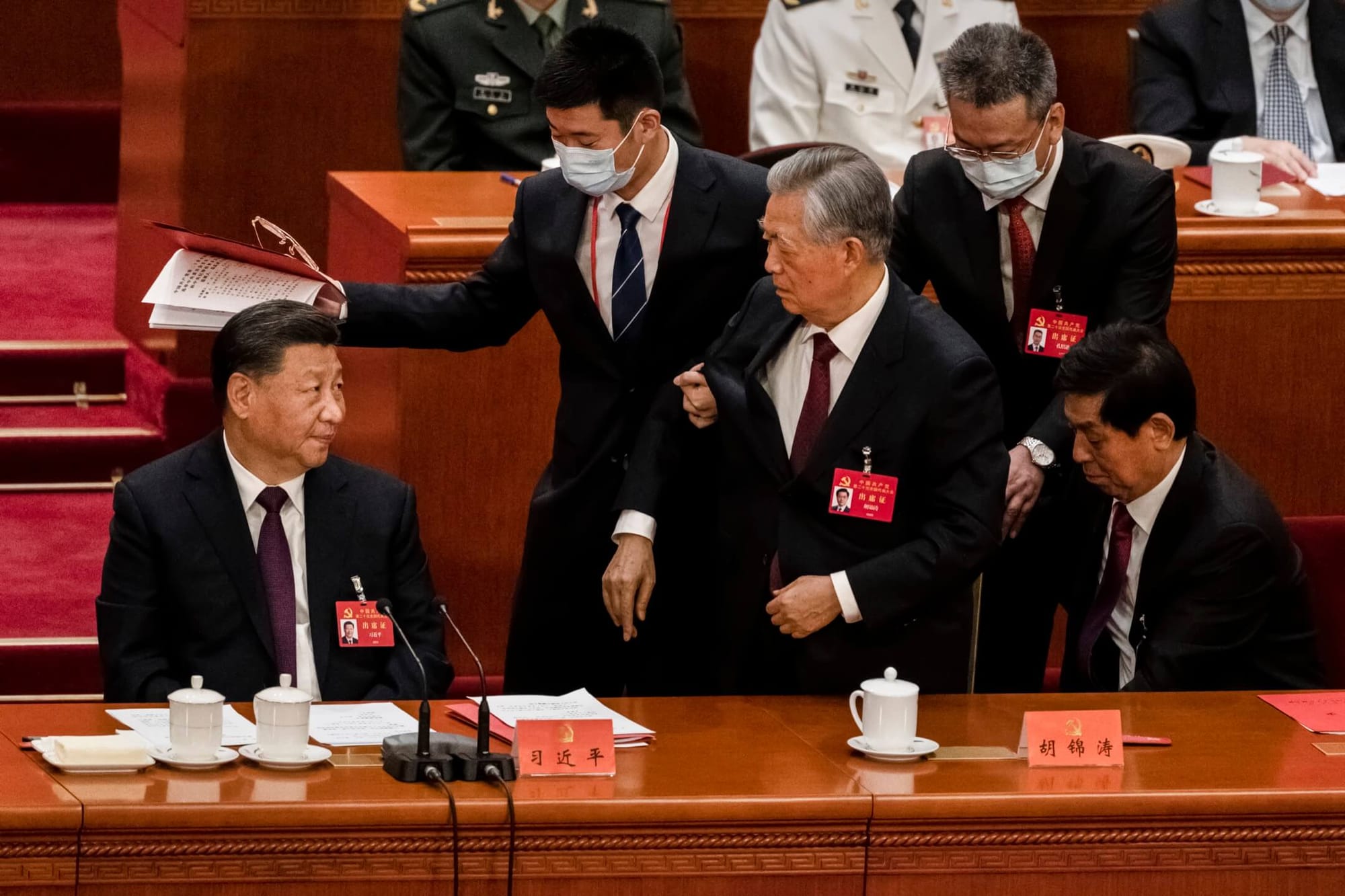 2022年10月22日，中国北京，人民大会堂举行的中共二十大闭幕期间，前中共总书记胡锦涛被工作人员从座位带走。