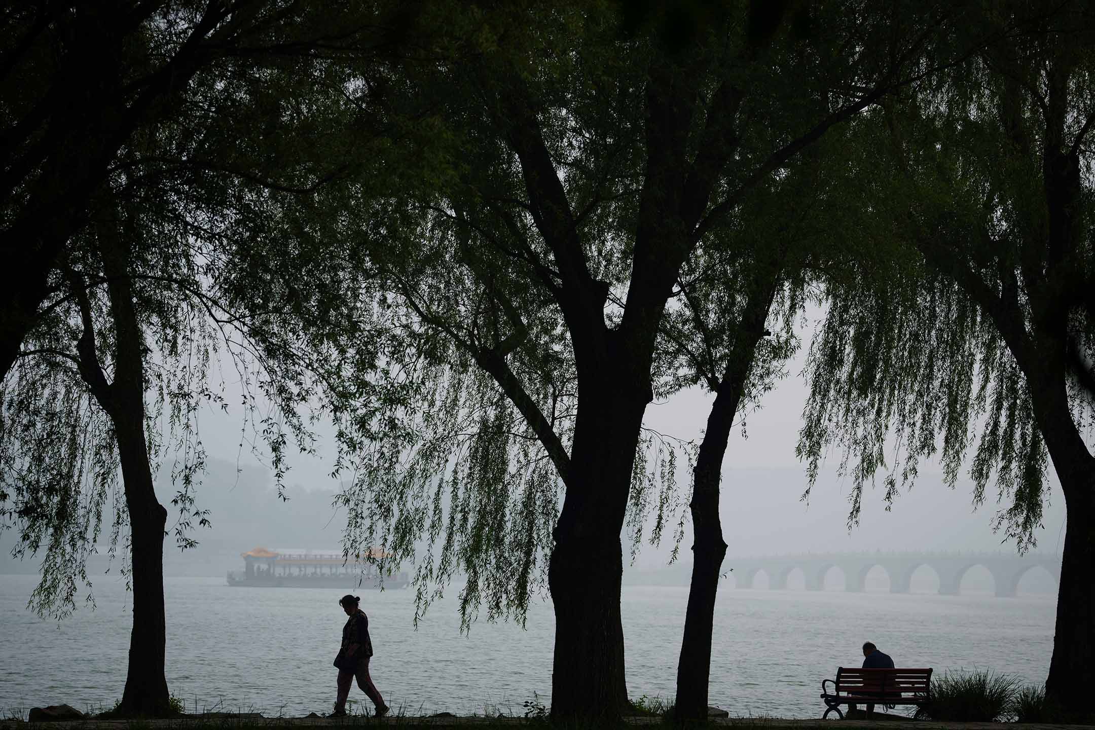 2024年7月5日，中国北京，人们坐在海旁。摄：Vincent Thian/AP/达志影像